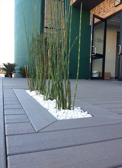 Decking with a close up view of a plant fixture built in
