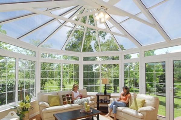 Two women enjoying a hybrid victorian conservatory