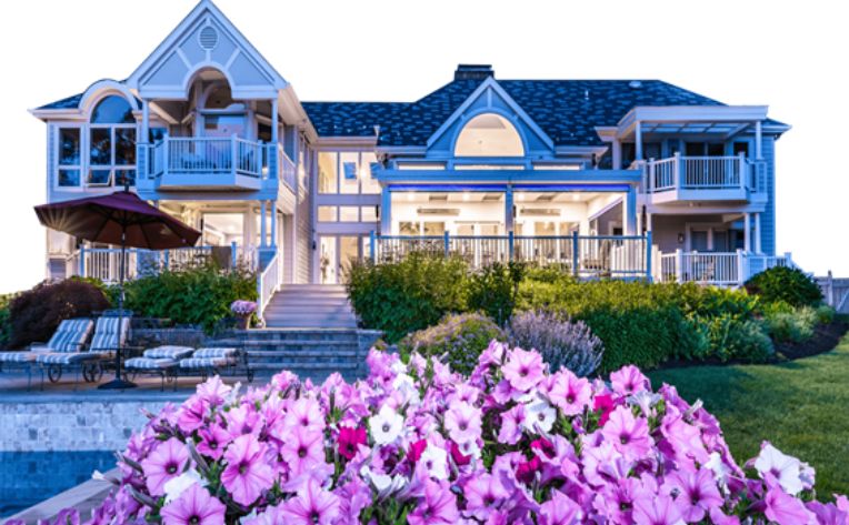a LifeRoom patio room at night with outdoor furniture under it and illuminated lights overhead