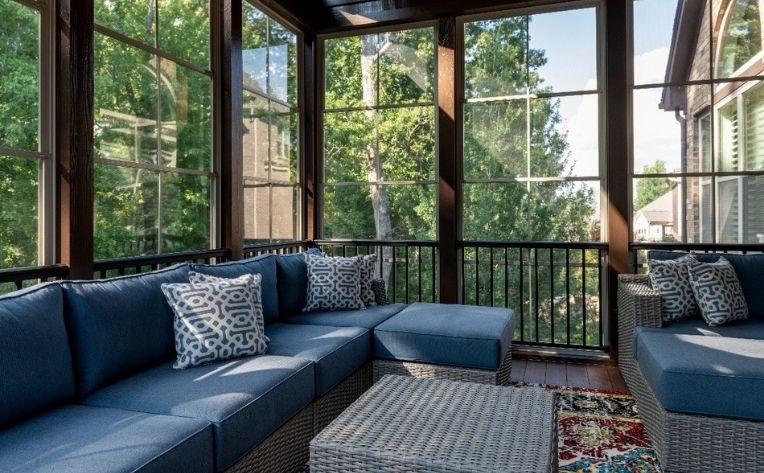 Sunroom with grey sofa set and a centre table