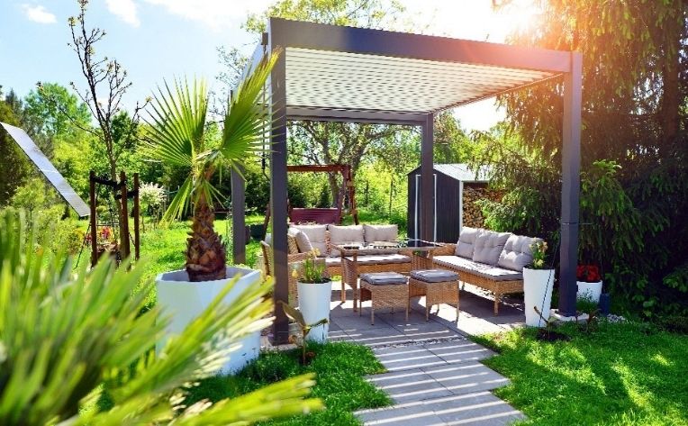 Pergola with a sofa set under it