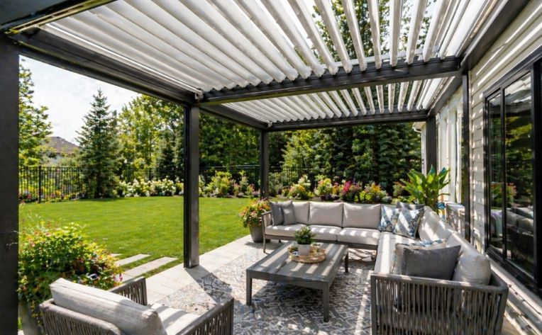 A bright louvered roof pergola with seating.